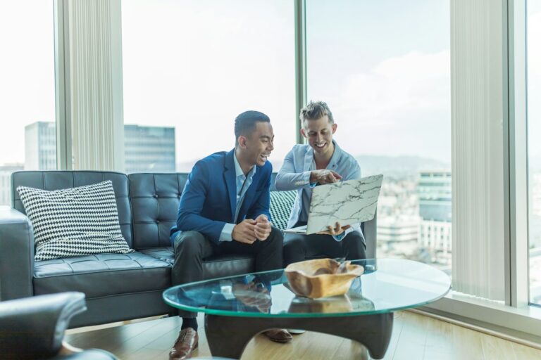 Tenant reviewing a commercial lease beside floor plans, keys, and a calculator on a desk